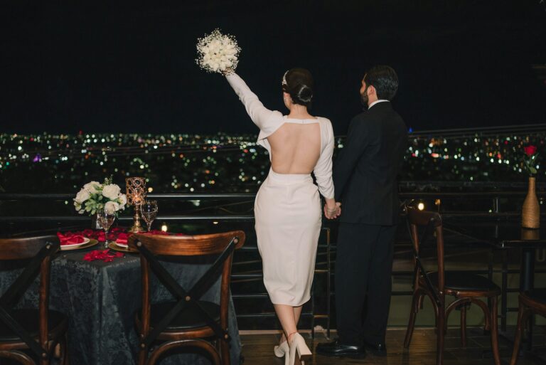 Couple on a terrace overlooking city lights at night