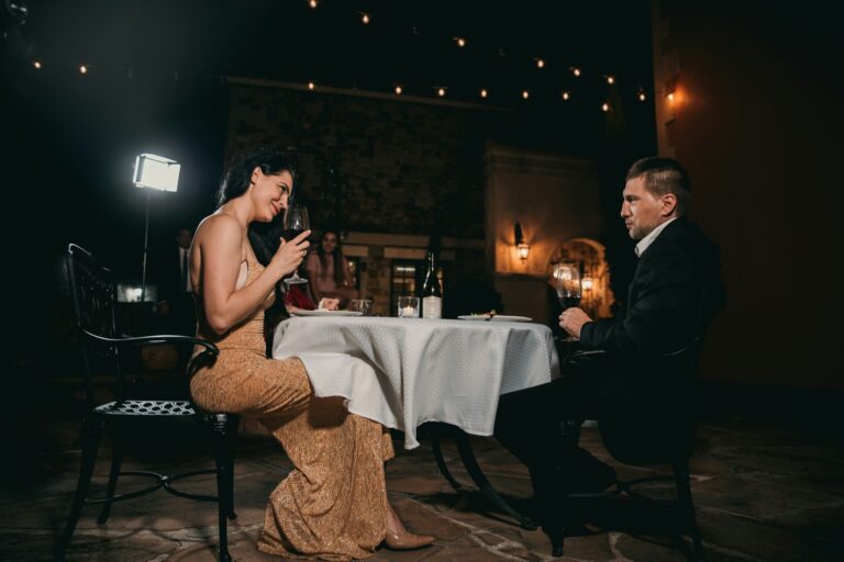 Couple at a candlelit dinner table at night